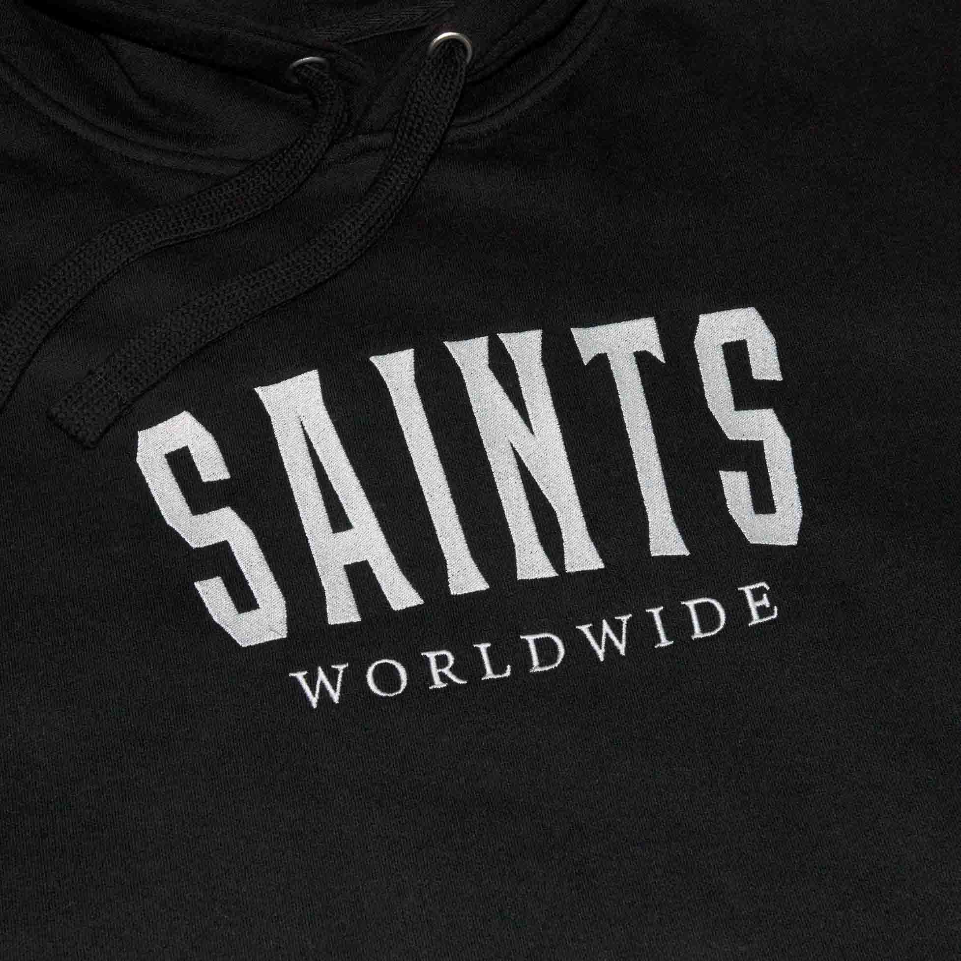 Close-up of Saints Worldwide logo embroidered on front of black Christian hoodie